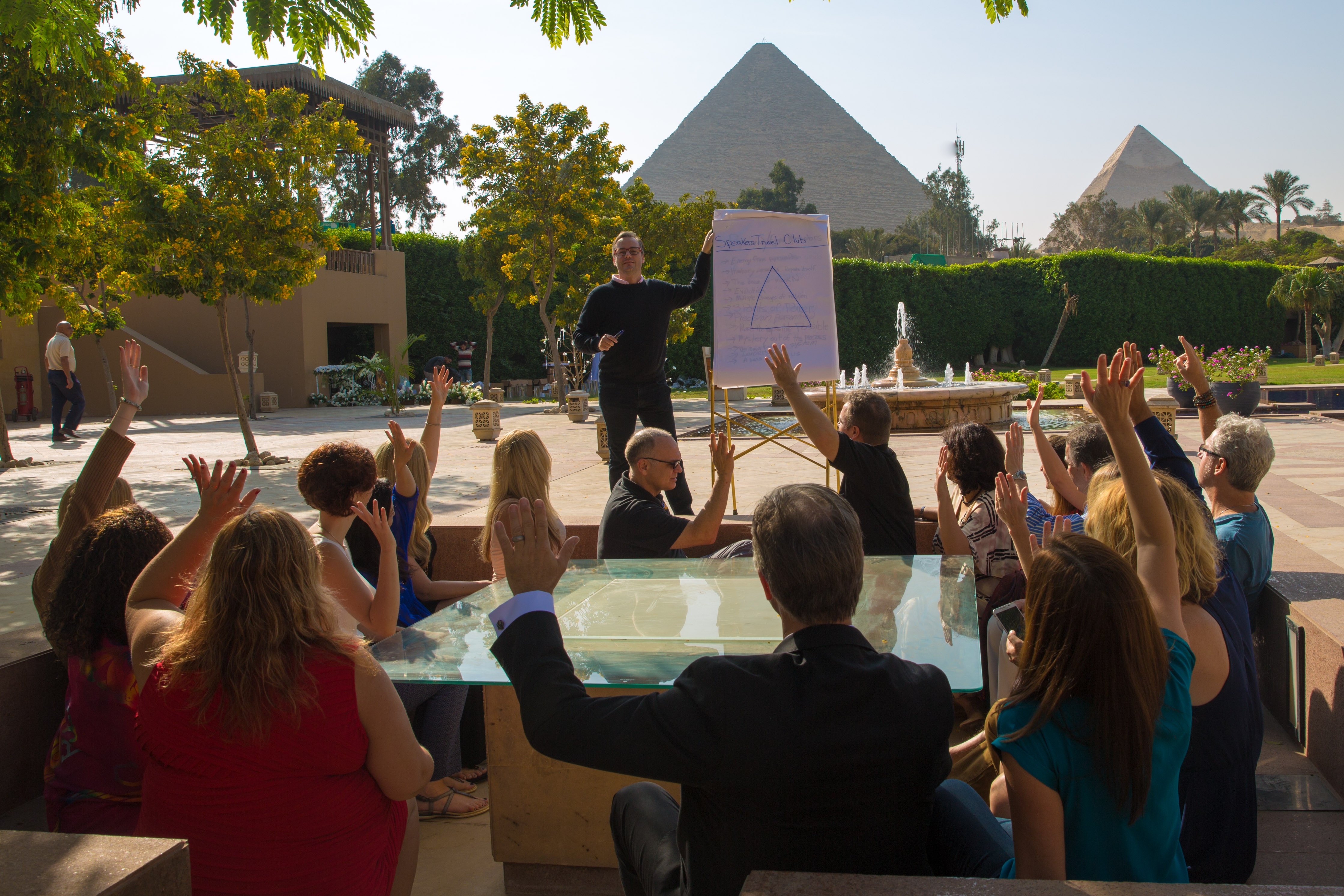 Prof. Christian Farioli leading an interactive workshop in Cairo, with the pyramids in the background