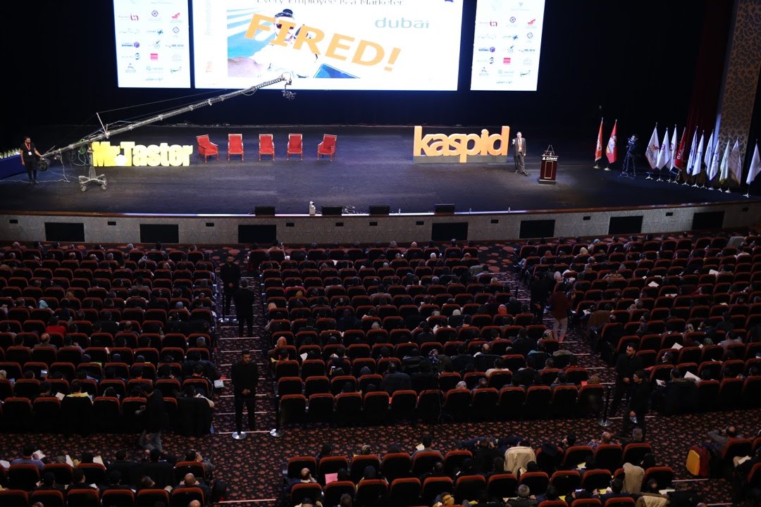 Prof. Christian Farioli speaking to a conference audience from the stage